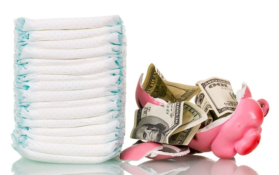 A stack of diapers, broken piggy bank and money isolated on white background. Incontinence Supplies for low income people are out there; You just need to know how to find them.