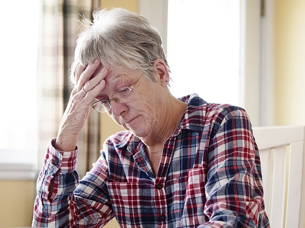 Image of a worried elderly woman