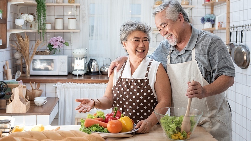 Senior couple cooking in the kitchen