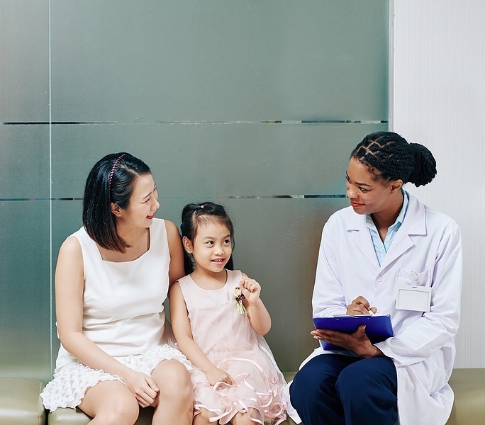 Mom and child talking to a friendly doctor