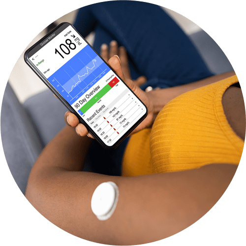 A woman checking her CGM reading on her smart phone