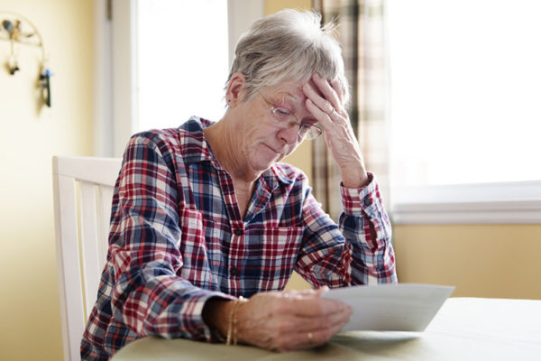 upset woman looking at a bill