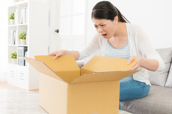 upset woman opening box