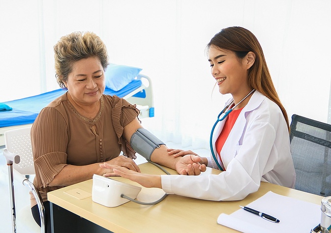 woman getting her blood pressure measured woman getting her blood pressure measured
