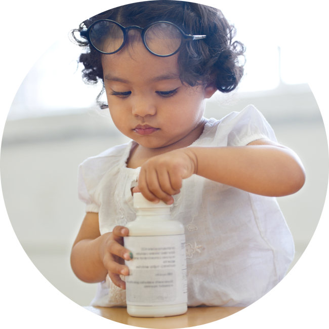 Child with an adult's medicine bottle