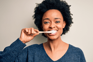 happy woman brushing her teeth