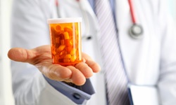 doctor holding prescription bottle
