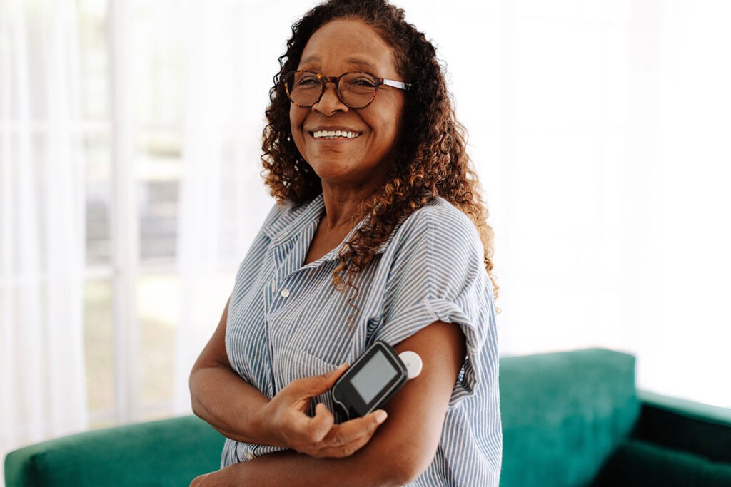 Woman using CGM device