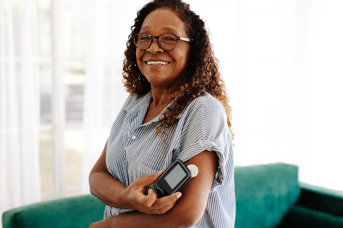 Woman using CGM device