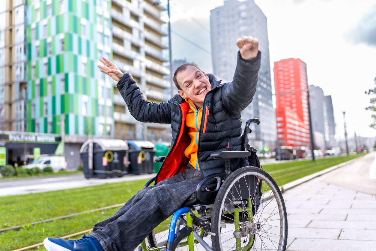 Man in wheelchair with hands in the air smiling Man in wheelchair with hands in the air smiling