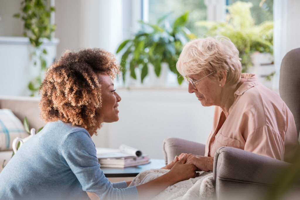 Home healthcare visit with a care professional providing personalized support and product guidance for an older adult