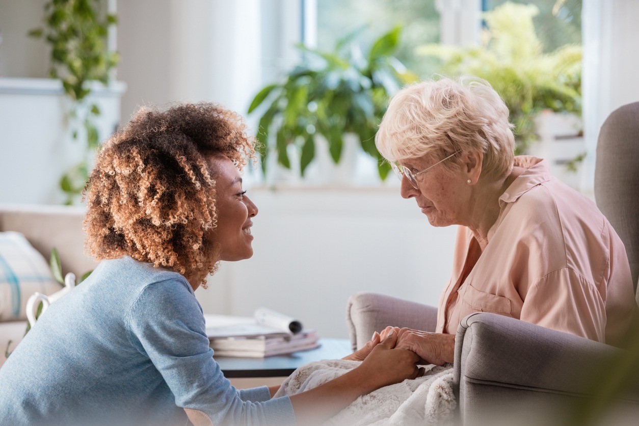 Home healthcare visit with a care professional providing personalized support and product guidance for an older adult Home healthcare visit with a care professional providing personalized support and product guidance for an older adult
